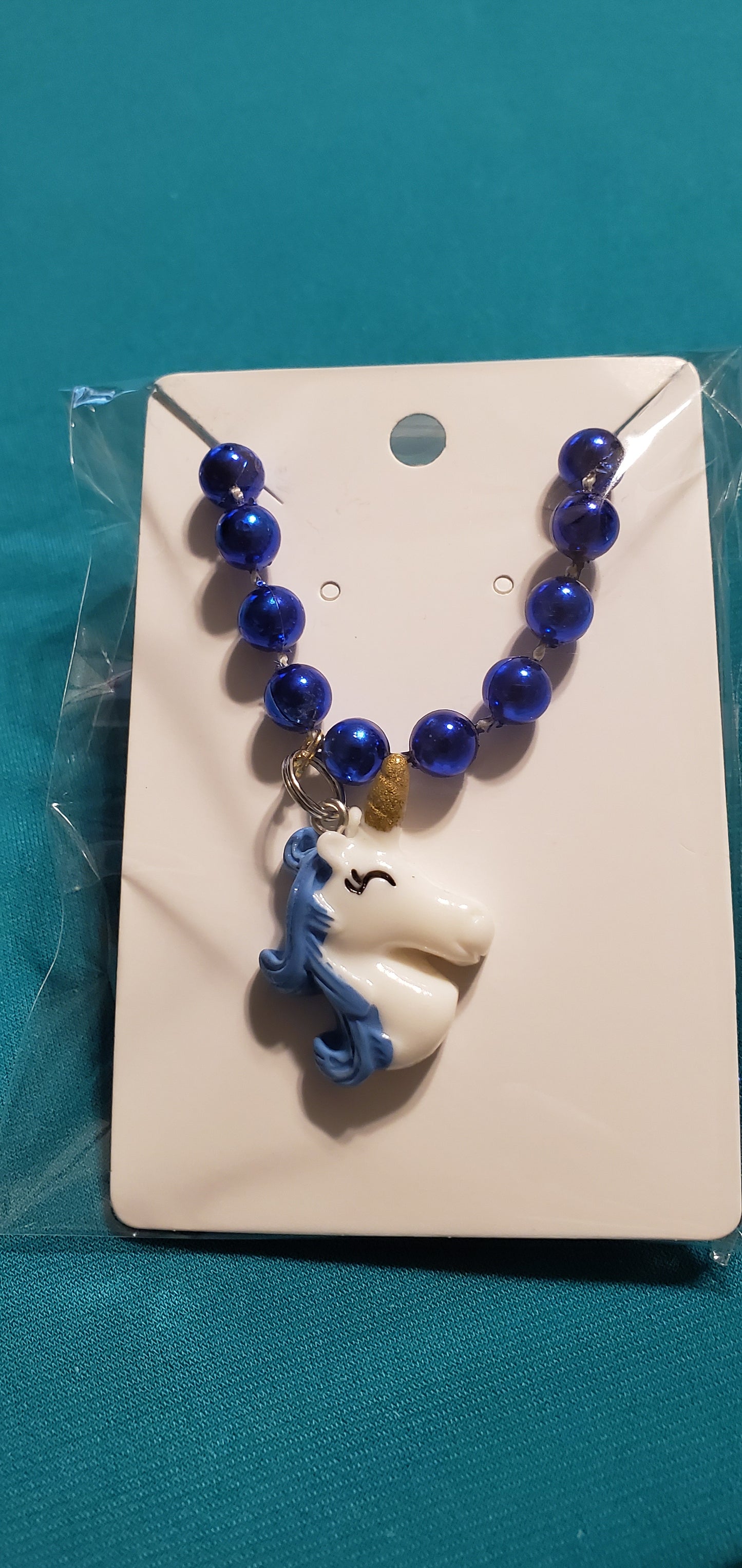 Blue &white Unicorn on blue beaded necklace