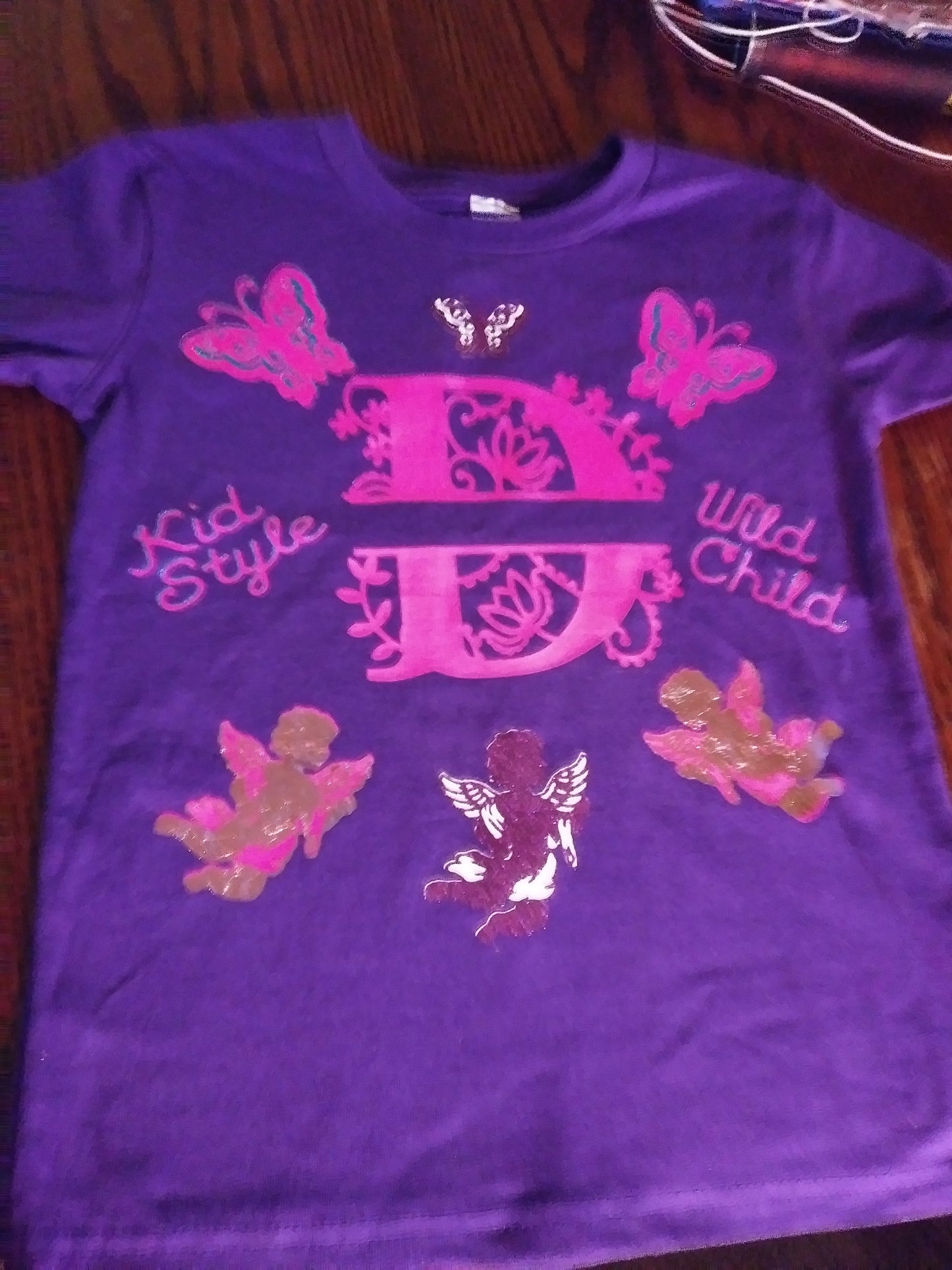 Purple shirt with the letter D